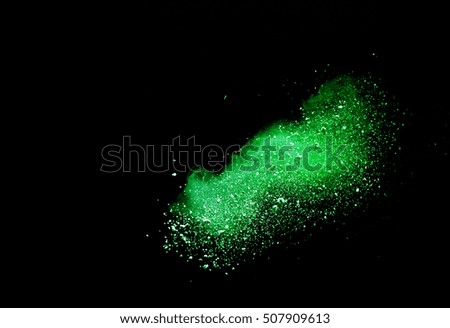 abstract green  powder splatted background,Freeze motion of color dust exploding/throwing color powder,color glitter texture on black background