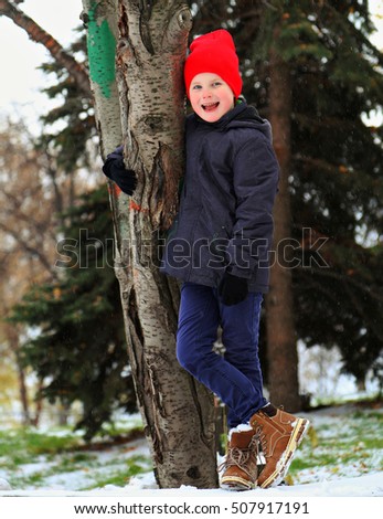 Beauty little boy in trendy winter clothes