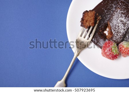 A chocolate fudge brownie pudding on a blue background forming a page border