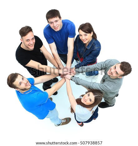 Top view of young people with their hands together in a circle.