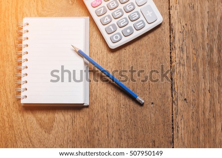Blank notebook with pencil on table background / selective focus