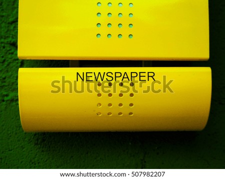 Yellow newspaper Box with Green wall, Post.