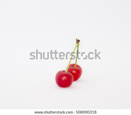 Ripe cherries with green leaves.