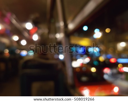abstract blurry traffic road bokeh light view from inside a car bus , night cityscape background in thailand