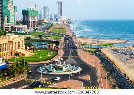 Aerial view of Colombo, Sri Lanka modern buildings with coastal promenade area. Car traffic during the day. Ocean waves Royalty-Free Stock Photo #508047703
