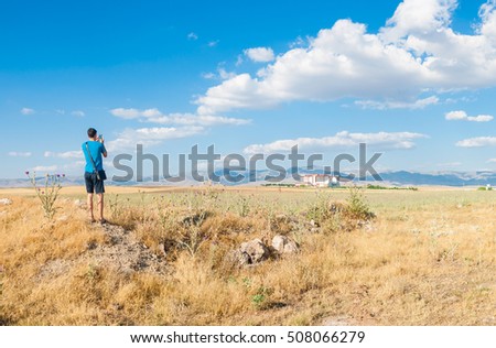 Young man is taking a photo of picturesque place in Sandikli, Turkey