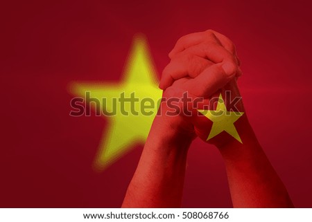 Man clasped hands patterned with the VIETNAM flag