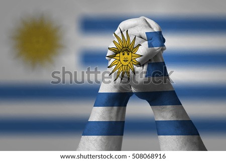 Man clasped hands patterned with the URUGUAY flag