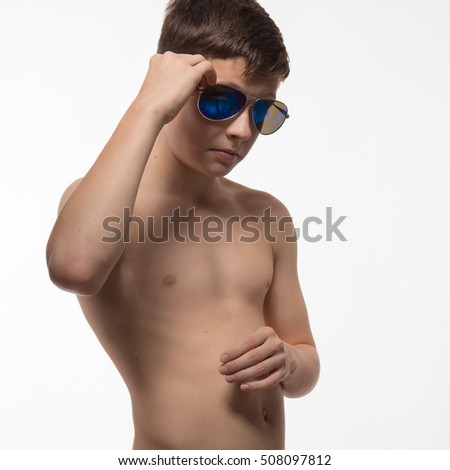 Actor athlete brunette boy in sunglasses on a white background