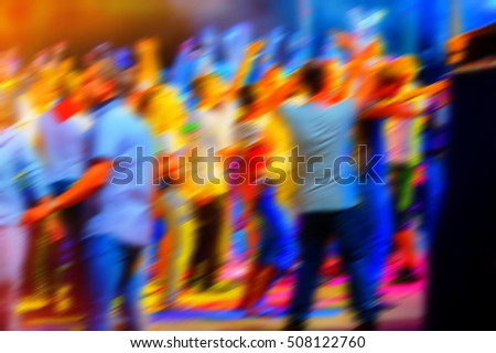 young people relax and dance in a disco night, blurred background
