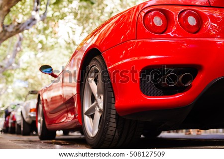 Back view of red ferrari. Exhaust and headlights Royalty-Free Stock Photo #508127509