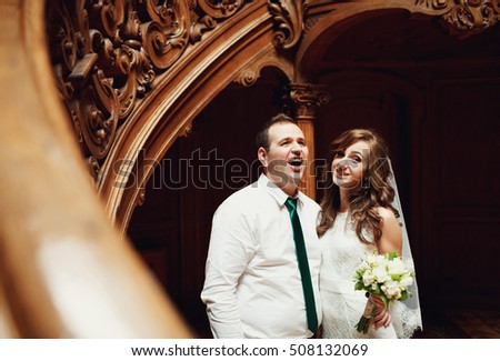 The lovely couple in love stand near stairs