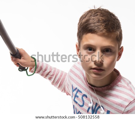 Actor brunette teenager boy in a pink jumper with a baton on a white background