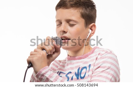 singer brunette teenager boy in a pink jumper with a microphone on a white background