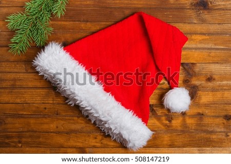  Santa Claus hat on wooden desk with blank copy space, top view