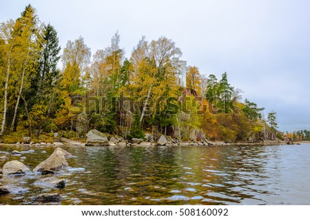 Autumn landscape on the rocky shore of the lake
