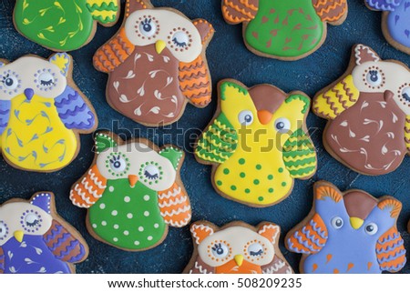 Homemade gingerbread cookie in the form of owls on the wooden table. Space for text and selective focus.
