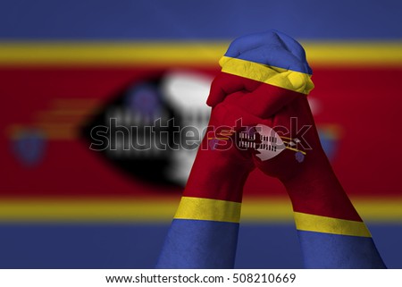Man clasped hands patterned with the SWAZILAND flag