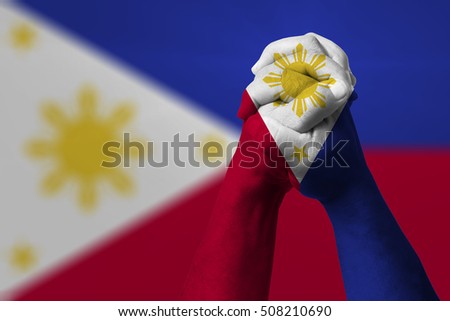 Man clasped hands patterned with the PHILIPPINES flag