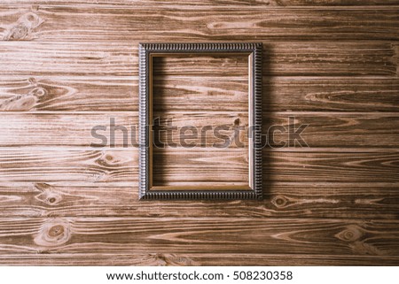 vintage photo frame on wooden board background texture