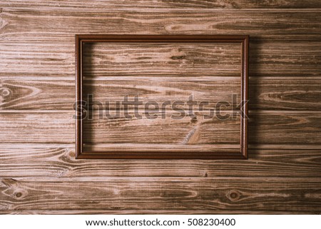 vintage photo frame on wooden board background texture