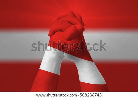 Man clasped hands patterned with the AUSTRIA flag