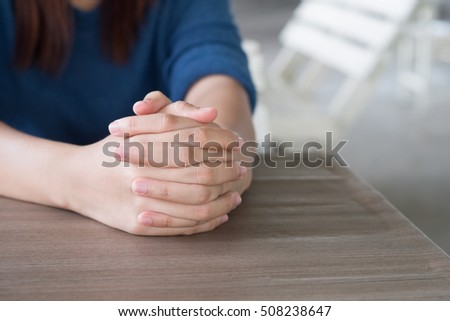 Hands clasped together on table,Two human hands,praying