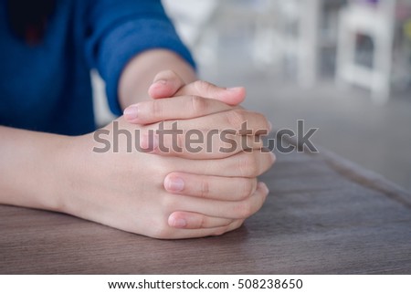Hands clasped together on table,Two human hands,praying