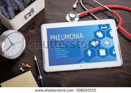 Pneumonia on screen tablet pc, health concept. Information technology and mobile application in healthcare/medical.