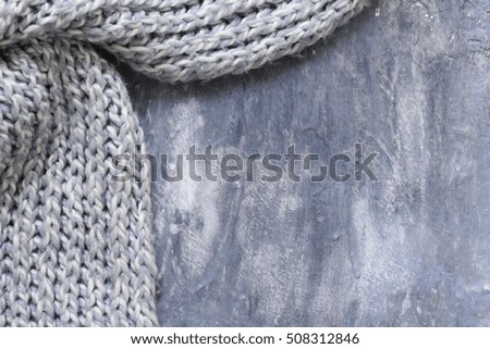 Gray background with beautiful knitted scarf