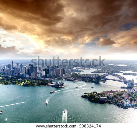 Magnificence of Sydney Harbour at sunaet, aerial view from helicopter.