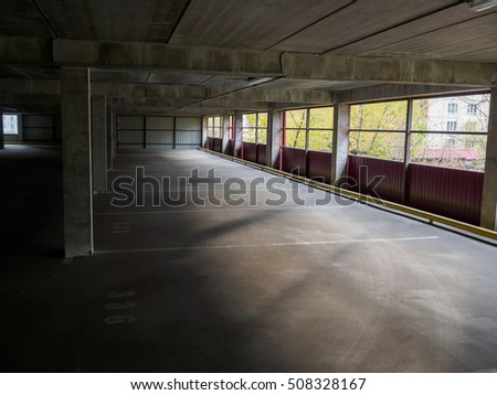 The empty automobile parking overlooking the city. Concrete walls.