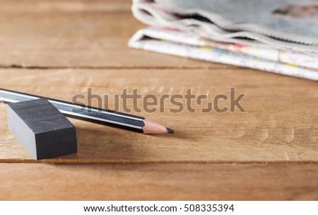 Eraser and pencil, Mistake erase concept, Pencil with eraser and newpaper on wooden table