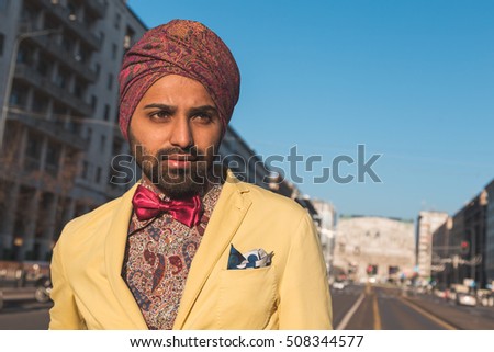Portrait of an Indian young handsome man posing in an urban context