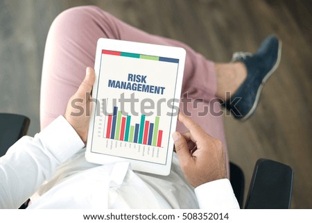 Business Charts and Graphs on screen with RISK MANAGEMENT Title