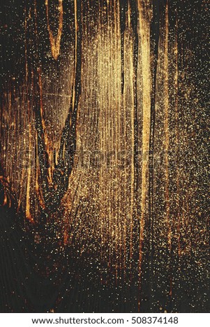 Wooden textured background with colden glitter. 