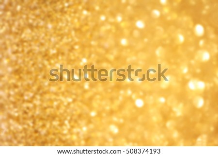 		Golden glitter Christmas abstract background with defocused sparkle lights 