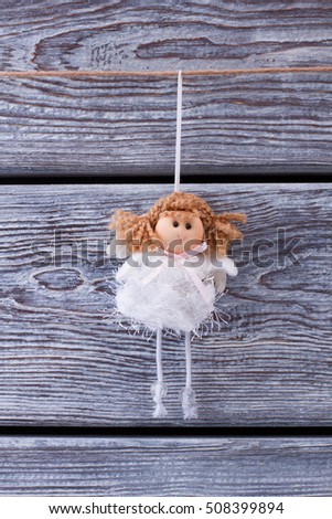 Cute princess on a wooden fence. Christmas toy. Little girl fairy.