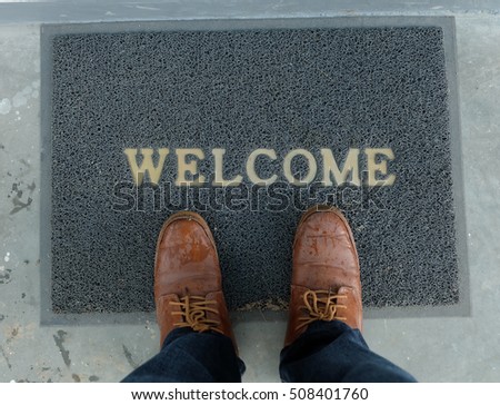 Welcome carpet with foot-ware on it