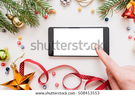 Woman using smartphone with blank screen, festive trumpery frame. Christmas gift search, online shopping, seasonal discounts and sale concept Royalty-Free Stock Photo #508413553