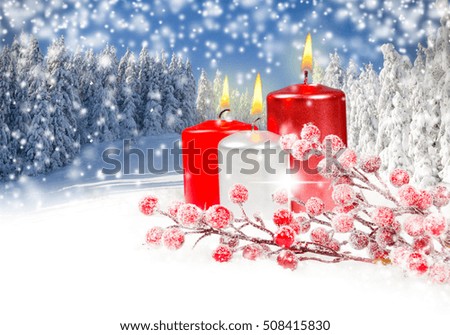 Photo of red Christmas candles with red baubles, falling snow and white space