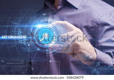 Business, Technology, Internet and network concept. Young businessman working on a virtual screen of the future and sees the inscription: get organized