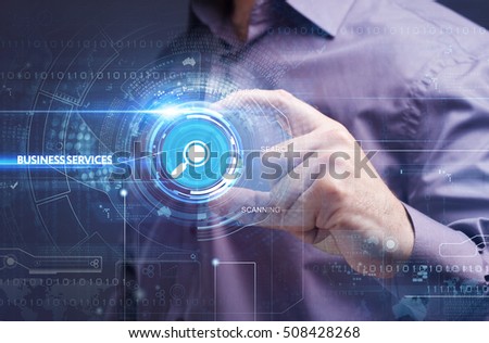 Business, Technology, Internet and network concept. Young businessman working on a virtual screen of the future and sees the inscription: business services