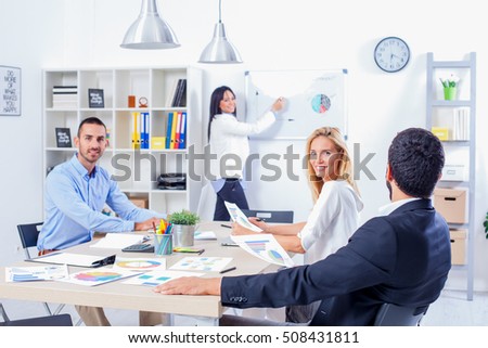 Group Of Business People Having Meeting In Office. Business partners discussing documents and ideas at meeting