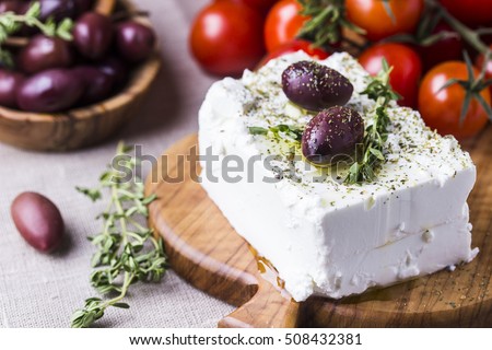 Greek cheese feta with thyme and olives, selective focus Royalty-Free Stock Photo #508432381