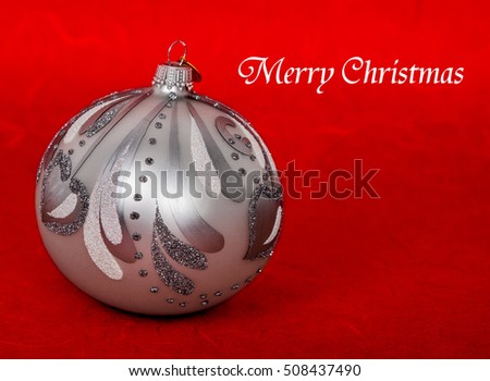 Silver Christmas bauble on red abstract  background