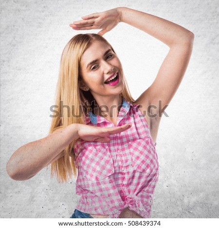 Happy young blonde girl on textured background