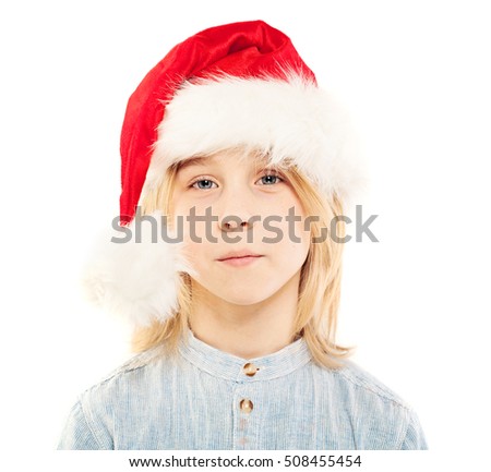 Young Boy in Santa Hat Isolated on White Background. Christmas Child