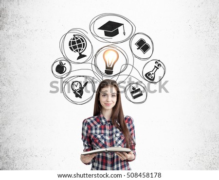 Smiling nerdy girl with a book is standing near concrete wall with black education icons. Concept of importance of knowledge