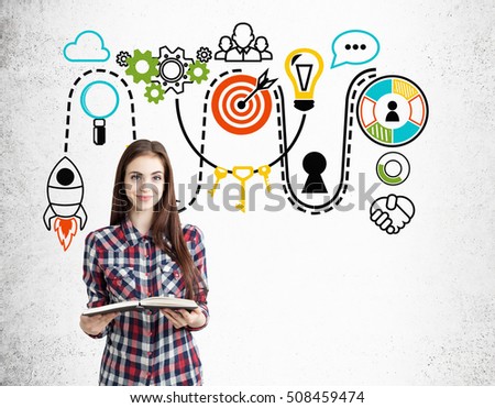 Smiling nerdy girl with a book is standing near concrete wall with colorful startup icons. Concept of startup foundation